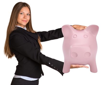 Businesswoman holding big piggy bank. Isolated on white background