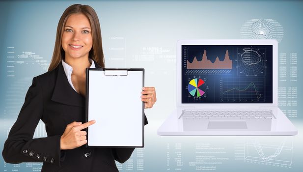 Businesswoman holding paper holder. Open laptop with high-tech graphs  as backdrop