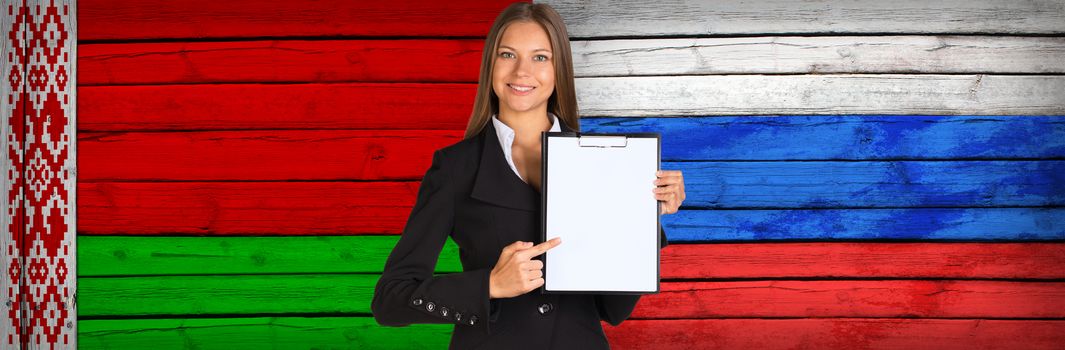 Businesswoman holding paper holder. Belarus and Russian flags as backdrop