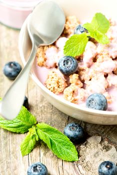 Cereal with yogurt and fresh blueberries, selective focus