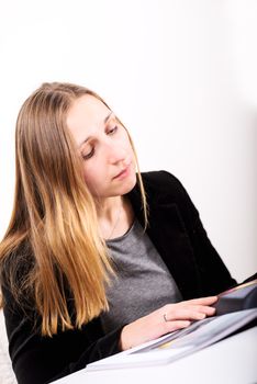 Young woman reading magazine