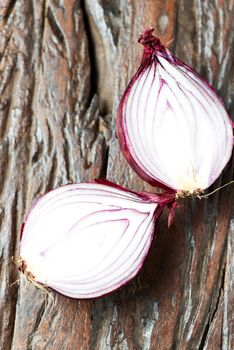 Fresh red onions on an old wooden table