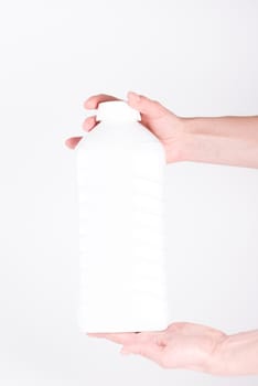 Holding white plastic bottle on a white background