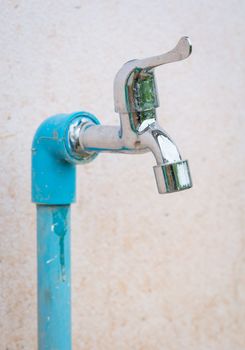 The Old Water Tap in the Open area with concrete background