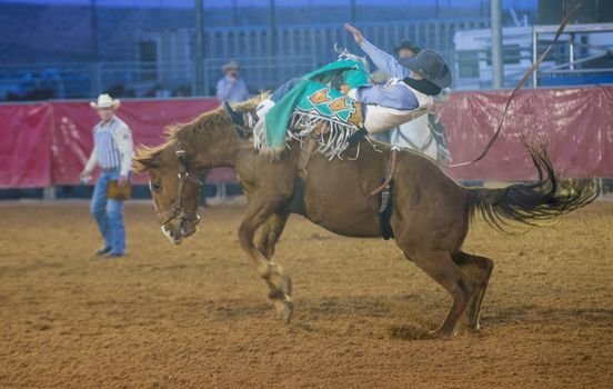 LOGANDALE , NEVADA - APRIL 10 : Cowboy Participating in a Bucking Horse Competition at the Clark County Fair and Rodeo a Professional Rodeo held in Logandale Nevada , USA on April 10 2014 