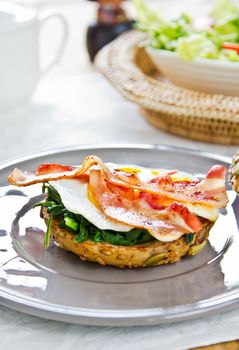 Bacon ,Fried egg and steamed spinach on Pumpkin bread breakfast