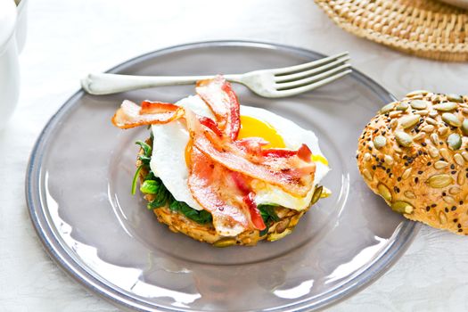 Bacon ,Fried egg and steamed spinach on Pumpkin bread breakfast