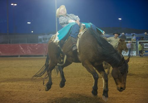 LOGANDALE , NEVADA - APRIL 10 : Cowboy Participating in a Bucking Horse Competition at the Clark County Fair and Rodeo a Professional Rodeo held in Logandale Nevada , USA on April 10 2014 