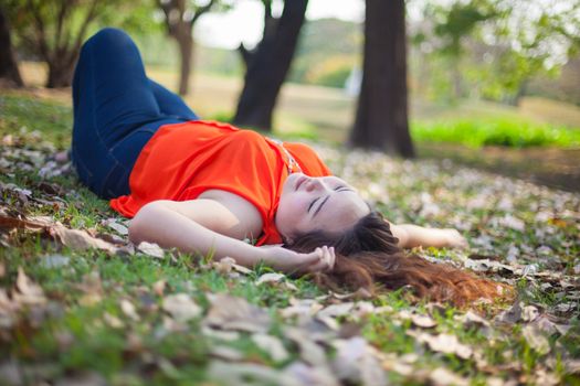 Happy fatty asian woman posing outdoor in a park