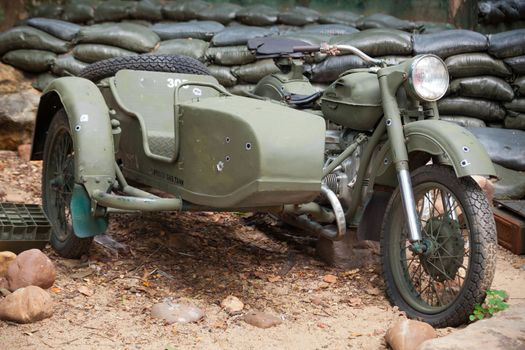 green old military motor bike on outdoor