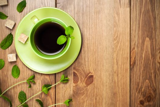 Tea mint with mint leaves on table background. Top view. Focus on tea