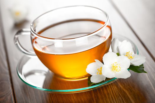 Jasmine tea with jasmine flower on table background