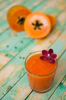 healthy fresh papaya smootie juice on wooden green boards