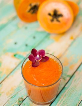 healthy fresh papaya smootie juice on wooden green boards