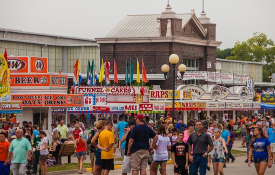 DES MOINES, IA /USA - AUGUST 10: Attendees at the Iowa State Fair. People walking near food vendors at the Iowa State Fair on August 10, 2014 in Des Moines, Iowa, USA.