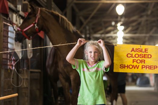 DES MOINES, IA /USA - AUGUST 10: Unidentified girl waiting with horse at Iowa State Fair on August 10, 2014 in Des Moines, Iowa, USA.