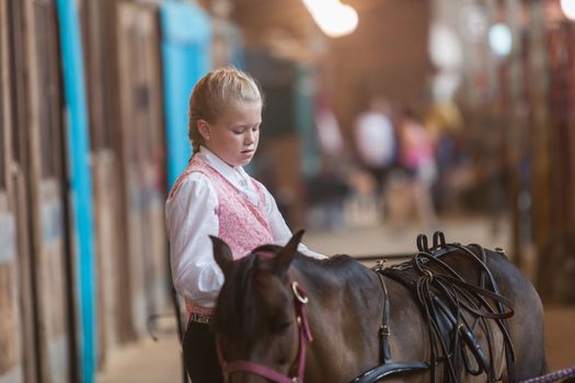 DES MOINES, IA /USA - AUGUST 10: Unidentified girl with miniature horse at Iowa State Fair on August 10, 2014 in Des Moines, Iowa, USA.