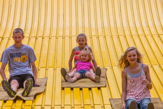 DES MOINES, IA /USA - AUGUST 10: Unidentified children on jumbo slide at the Iowa State Fair on August 10, 2014 in Des Moines, Iowa, USA.