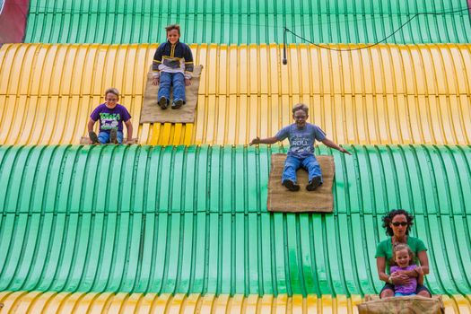 DES MOINES, IA /USA - AUGUST 10: Unidentified people on jumbo slide at the Iowa State Fair on August 10, 2014 in Des Moines, Iowa, USA.