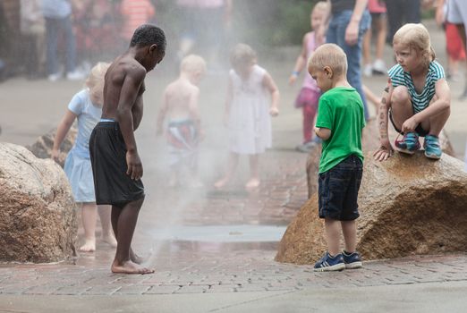 DES MOINES, IA /USA - AUGUST 10: Unidentified children play in fountain at the Iowa State Fair on August 10, 2014 in Des Moines, Iowa, USA.