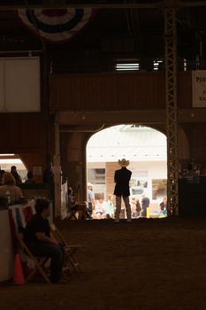 DES MOINES, IA /USA - AUGUST 10: Unidentified man waits for livestock to enter arena at Iowa State Fair on August 10, 2014 in Des Moines, Iowa, USA.