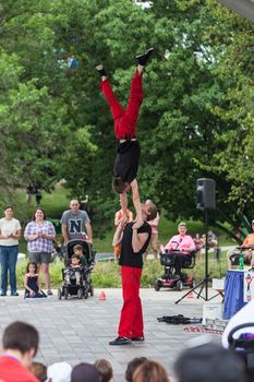 DES MOINES, IA /USA - AUGUST 10: Red Trouser Show acrobats David Graham, below, and Tobin Renwick at the Iowa State Fair on August 10, 2014 in Des Moines, Iowa, USA.