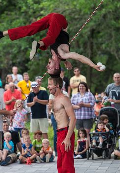 DES MOINES, IA /USA - AUGUST 10: Red Trouser Show acrobats David Graham, below, and Tobin Renwick at the Iowa State Fair on August 10, 2014 in Des Moines, Iowa, USA.