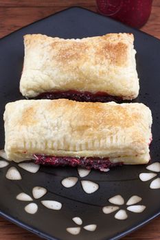 Fresh raspberry turnovers on a table sitting in natural light.