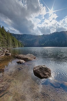Glacial Black Lake surrounded by the forest in South Bohemia