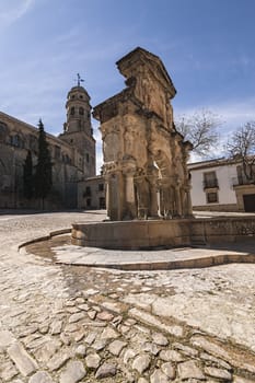 Baeza, Jaen province, SPAIN - 9 march 2014: Fountain and St. Philip Neri Seminary in the Plaza Santa Maria, Baeza, Jaen Province, Andalusia, Spain