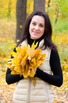 Photo of beautiful young brunette in autumn