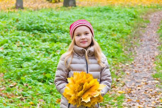 Photo of cute smiling girl in autumn