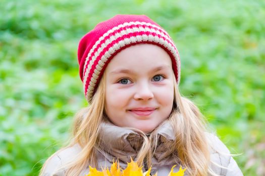 Photo of cute smiling girl in autumn