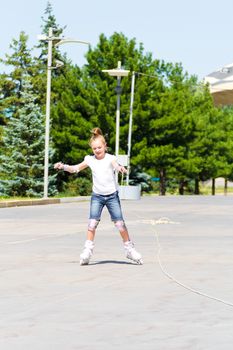 Photo of cute girl on roller skates in summer