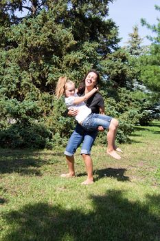 Photo of smiling playing mother and daughter