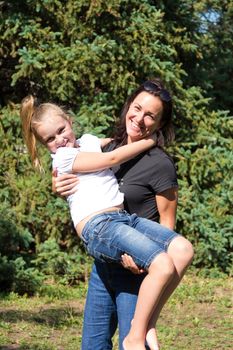 Photo of smiling playing mother and daughter