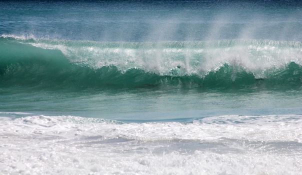 Big ocean wave breaking the shore
