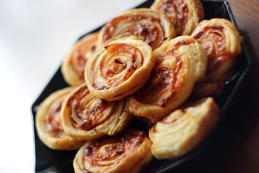 Dry spiral puff pastry as small pizzas