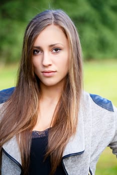 Portrait of a charming lady woman girl outdoor with green background