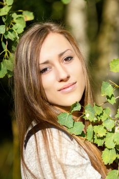 Portrait of smiling and charming lady woman girl outdoor with forrest in background 