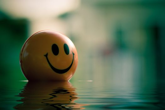 smiling ball on water