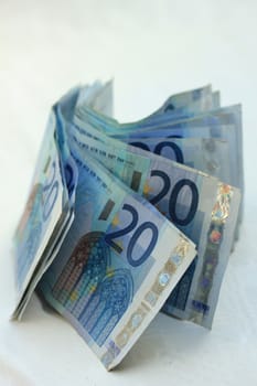 stacked 20 euro banknotes on white background