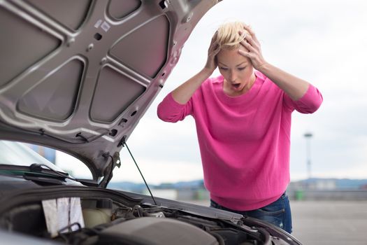 Stressed Young Woman with Car Defect. Engine breakdown.