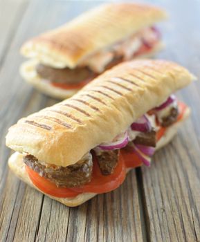 Beef steak sandwich with tomatoes and coleslaw