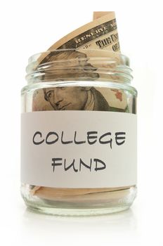 Glass jar filled with banknotes labeled with college fund
