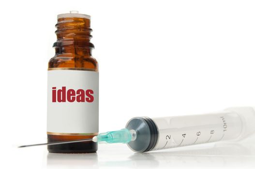 Metaphor for creativity with injection needle and  bottle labeled with idea 