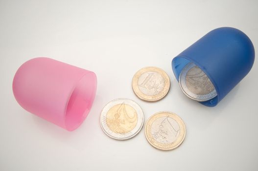 Open medicine pill with euro coins inside 