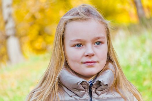 Photo of cute smiling girl in autumn