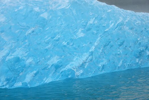 blue iceberg floating in alaska