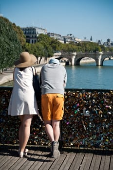 couple in the Arts bridge in Paris